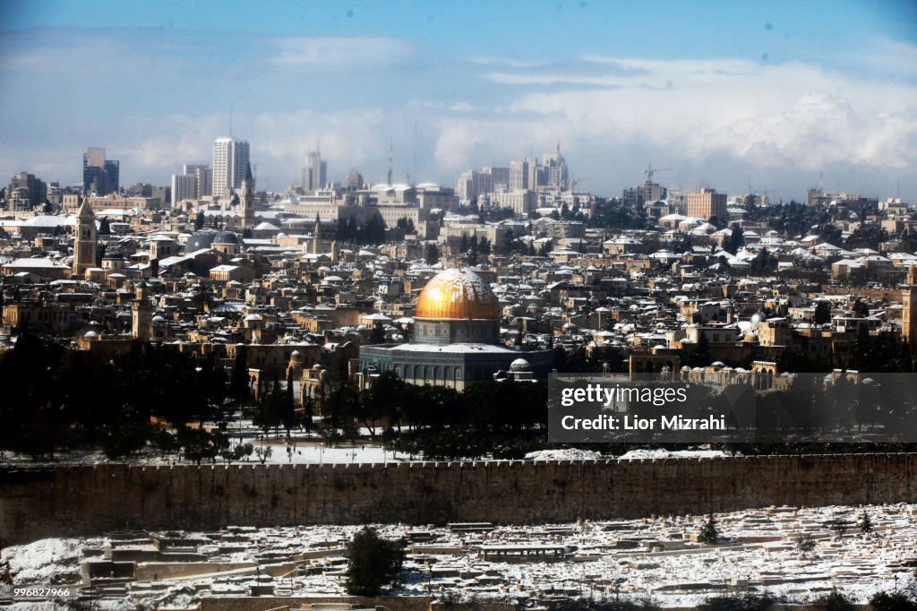 View of the Old City of Jerusalem and the Dome of the Rock in the snow From Mount of Olives
