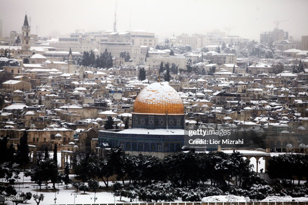 View of the Old City of Jerusalem and the Dome of the Rock in the snow From Mount of Olives