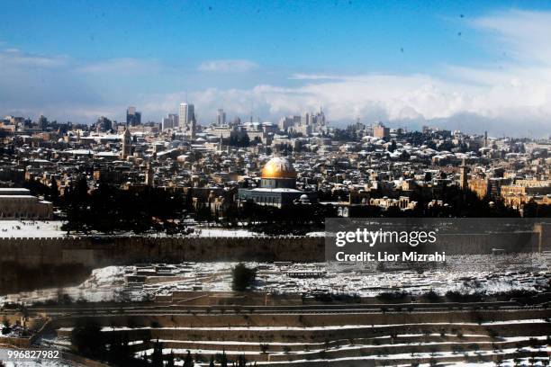 view of the old city of jerusalem and the dome of the rock in the snow from mount of olives - dome of the rock stock-fotos und bilder