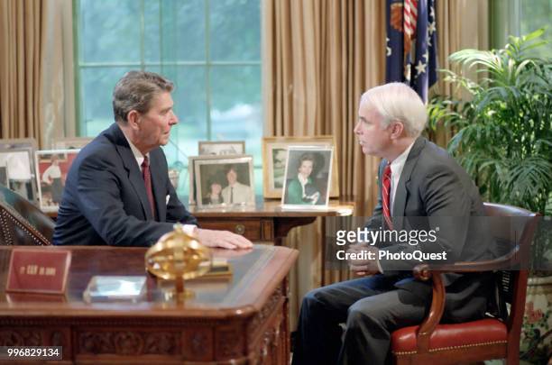 American politician US President Ronald Reagan meets with Senator John McCain in the White House's Oval Office, Washington DC, July 31, 1986. The...