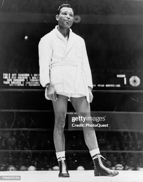 Low-angle view of American boxer Sugar Ray Robinson as he stands in the ring at Madison Square Garden for the last time, New York, New York, 1966.