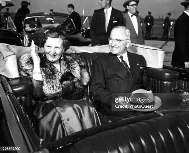 At National Airport, Queen Juliana of the Netherlands and US President Harry S Truman smile as they ride in a convertible during the former's state...