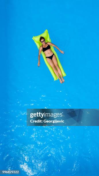 woman in the swimming pool - pool raft stock pictures, royalty-free photos & images