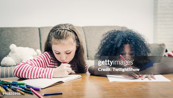 School girl and boy doing homework in home School girl and boy doing homework in home