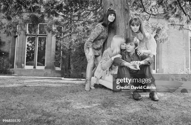 English musician and singer Georgie Fame pictured with his co-stars from the film 'The Mini-Mob', Lucille Soong, Gretchen Regan and Madeline Smith in...