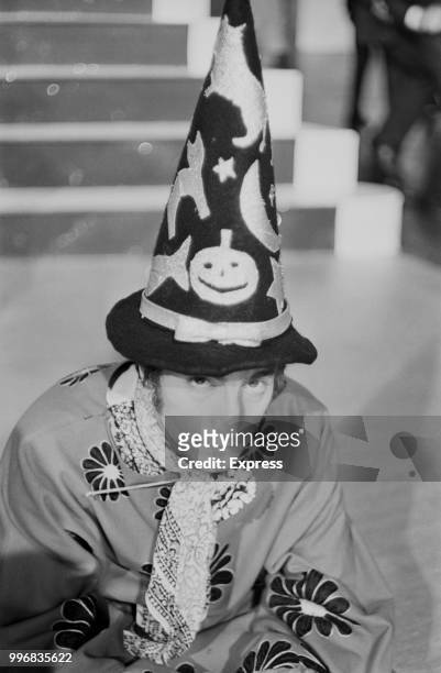 John Lennon , guitarist and singer with the Beatles, pictured wearing a wizard style hat during the final day of filming of 'Magical Mystery Tour' at...