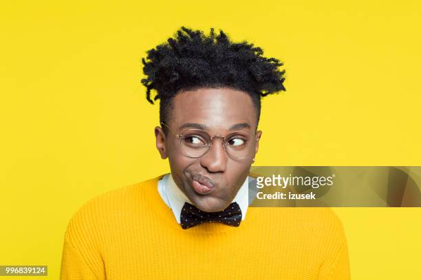 funny portrait of nerdy young man making decision - izusek stock pictures, royalty-free photos & images