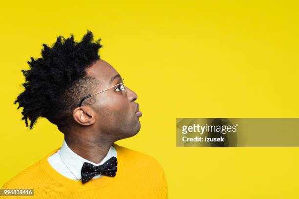 side view of nerdy young man looking at copy space - izusek stock pictures, royalty-free photos & images