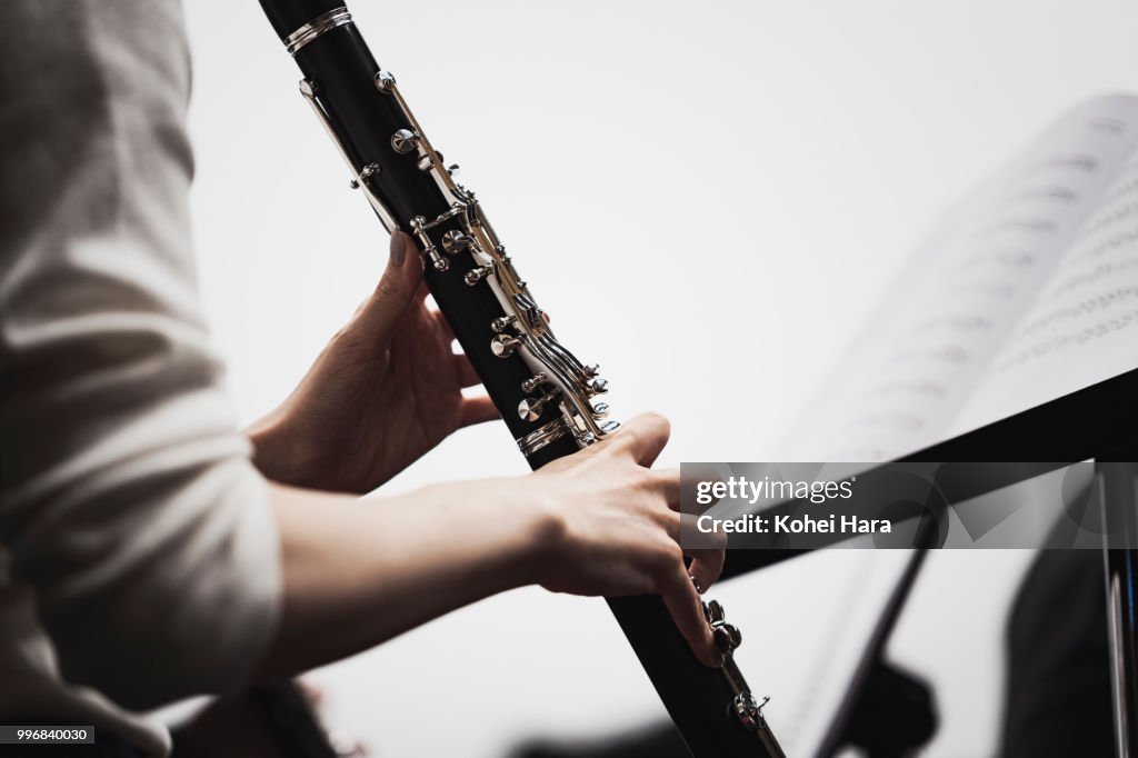 Woman playing a clarinet at concert hall in rehearsal