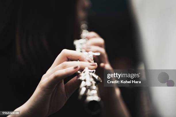 woman playing a flute at concert hall - klassiek-concert stockfoto's en -beelden