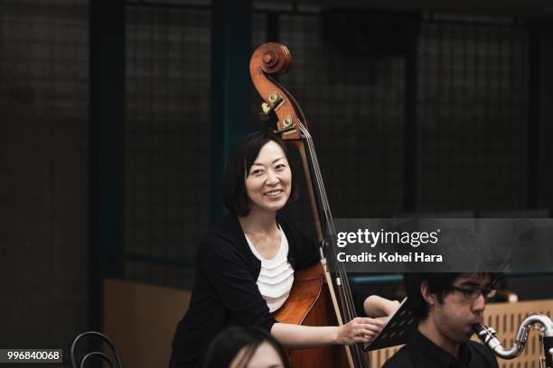 woman playing a contrabass at concert hall in rehearsal - klassisk orkestermusik bildbanksfoton och bilder