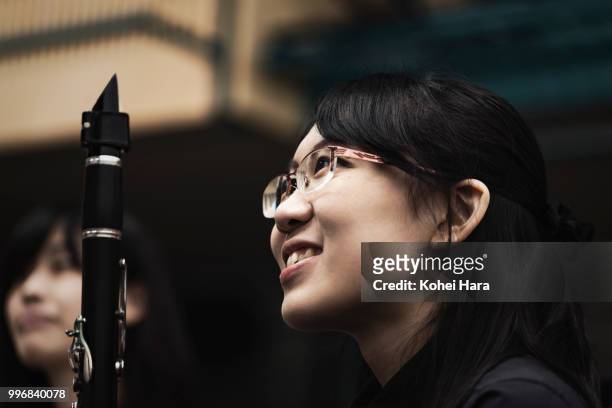 woman playing a clarinet at concert hall in rehearsal - klassisk orkestermusik bildbanksfoton och bilder