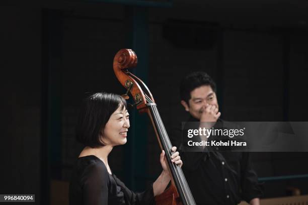 members of orchestra talking and smiling at concert hall - klassisk orkestermusik bildbanksfoton och bilder