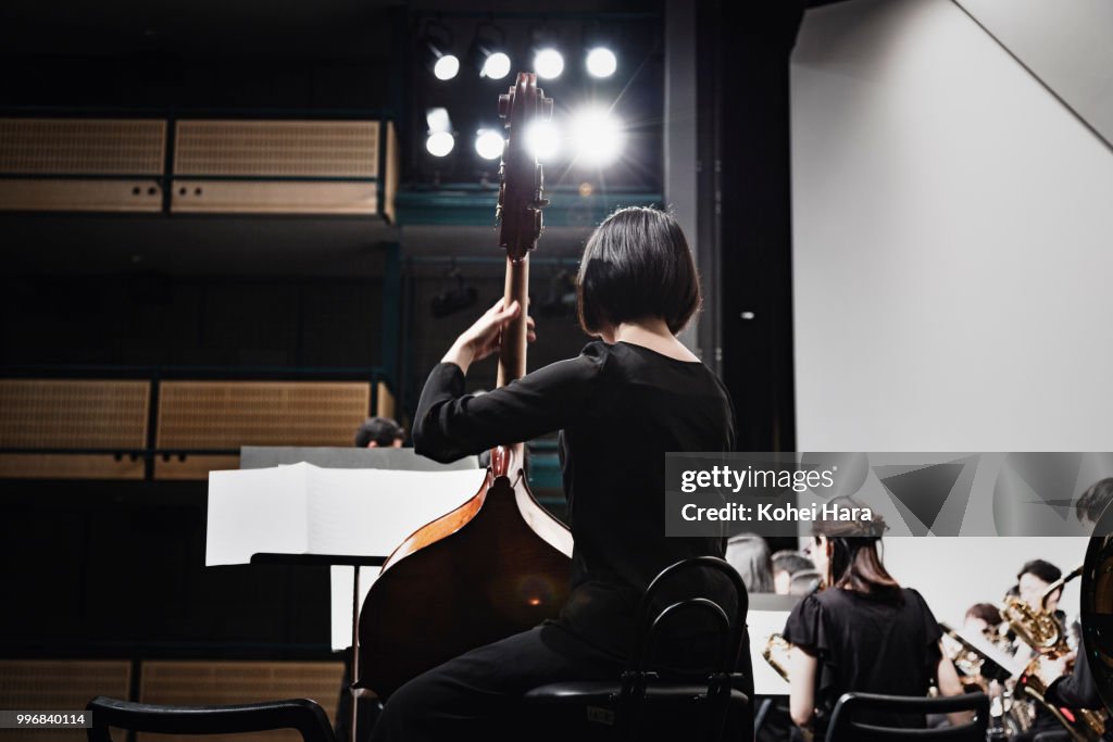 Woman playing a contrabass at concert hall