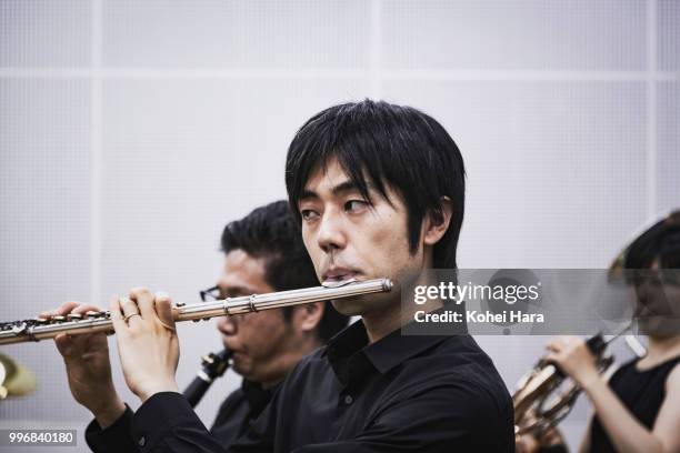 male flute player rehearsing in the rehearsal room - musician male energy imagens e fotografias de stock