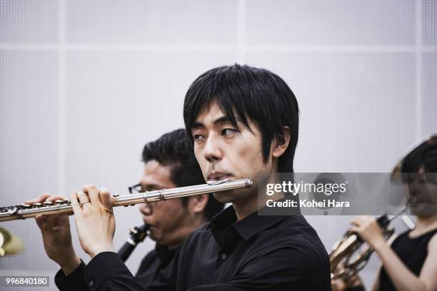 male flute player rehearsing in the rehearsal room - klassisk orkestermusik bildbanksfoton och bilder