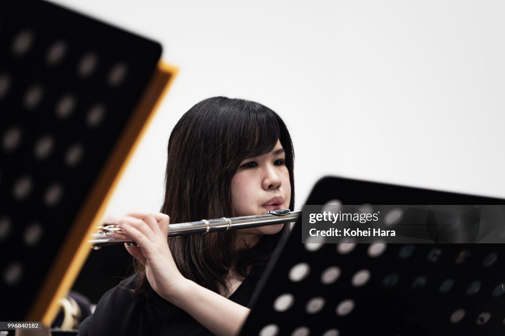 Woman playing a flute at concert hall