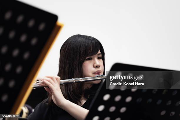 woman playing a flute at concert hall - klassisk orkestermusik bildbanksfoton och bilder
