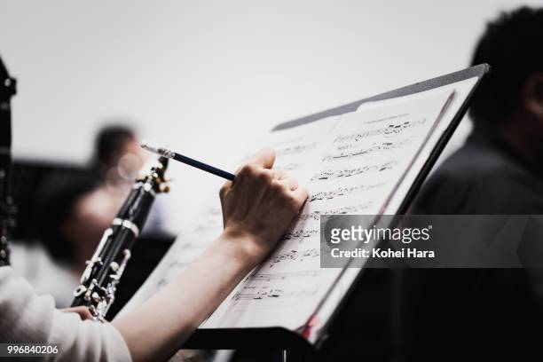 orchestra rehearsing at concert hall - wind instrument stock pictures, royalty-free photos & images