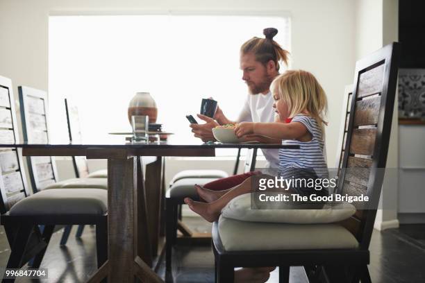 father and daughter having breakfast at table - sherman oaks bildbanksfoton och bilder