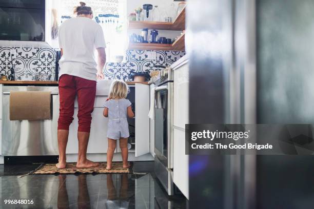 father and daughter in kitchen at home - kitchen cleaning stock pictures, royalty-free photos & images