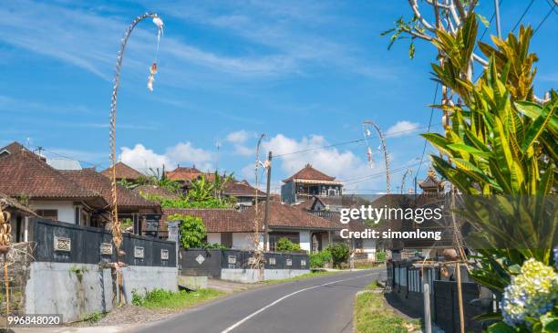 residential road decorated with bamboo poles in bali, indonesia - denpasar stock pictures, royalty-free photos & images