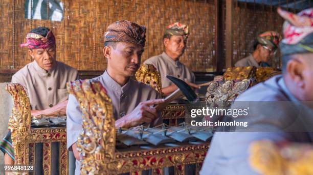 balinese performers playing gamelan music - denpasar stock pictures, royalty-free photos & images