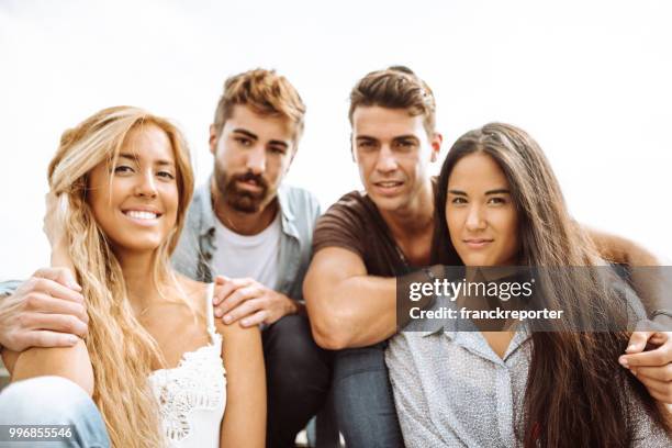 portrait of a group of friends all together sitting - franckreporter stock pictures, royalty-free photos & images