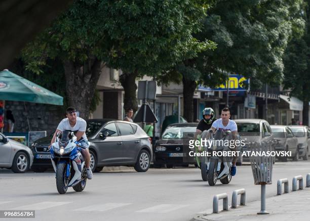 People ride motorbikes in the city of Veles on June 12, 2018.
