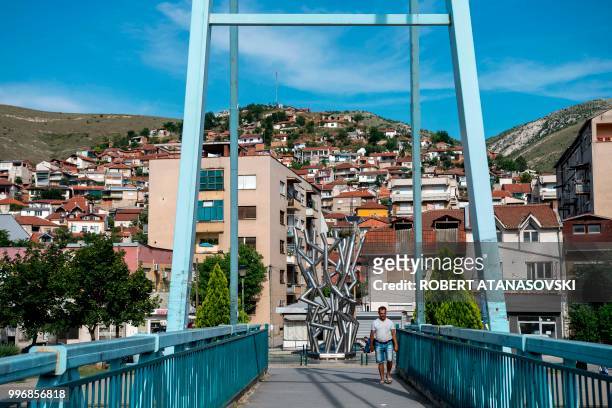 Person walks on a bridge in the city of Veles on June 12, 2018.