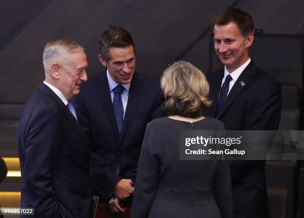 Defense Secretary James Mattis speaks with U.S. Permanent Representative to NATO Kay Bailey Hutchison and new British Foreign Secretary Jeremy Hunt...