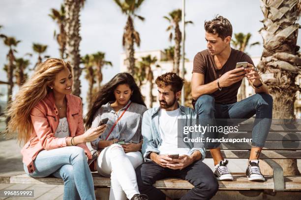 group of friends using social media all together - franckreporter stock pictures, royalty-free photos & images