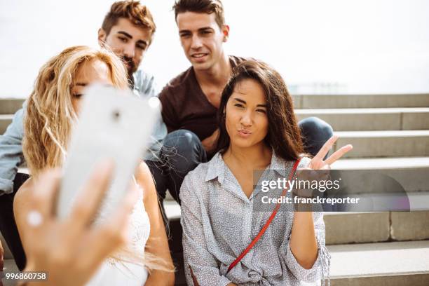 group of friends take a selfie all together in the steps - franckreporter stock pictures, royalty-free photos & images