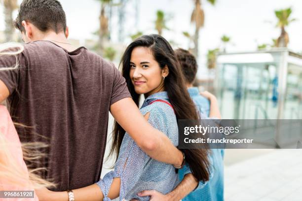 friends walking all together and looking back - franckreporter stock pictures, royalty-free photos & images