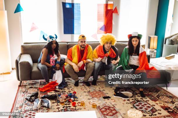 supporter cheering with beer in front of the tv - franckreporter stock pictures, royalty-free photos & images