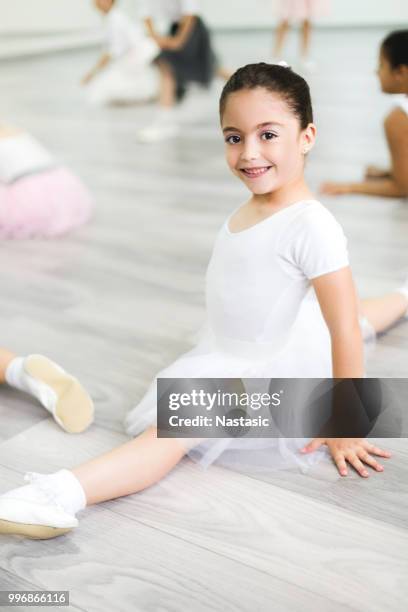 young ballerina poses on floor during class - leotard and tights stock pictures, royalty-free photos & images