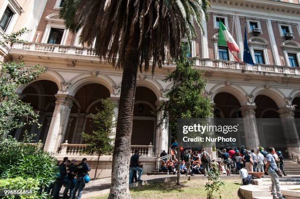 Protester is dragged away by Italian police outside the Ministry of Transport in Rome, Wednesday, July 11, 2018. Dozens of protesters chained...