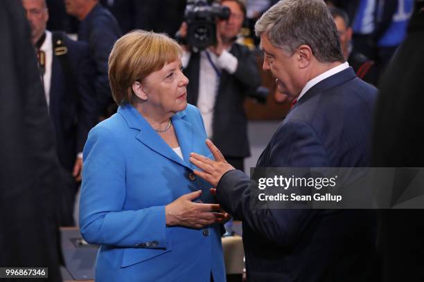 German Chancellor Angela Merkel chats with Ukrainian President Petro Poroshenko prior to a working session of NATO leaders and the delegations from...