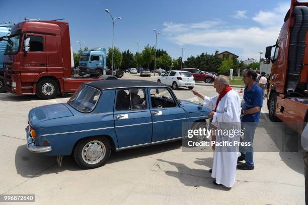 Father Jacinto Egido blesses a car on Saint Christopher's day, the patron saint of vehicles and drivers.