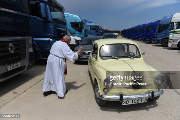 Father Jacinto Egido blesses a car on Saint Christopher's day, the patron saint of vehicles and drivers.