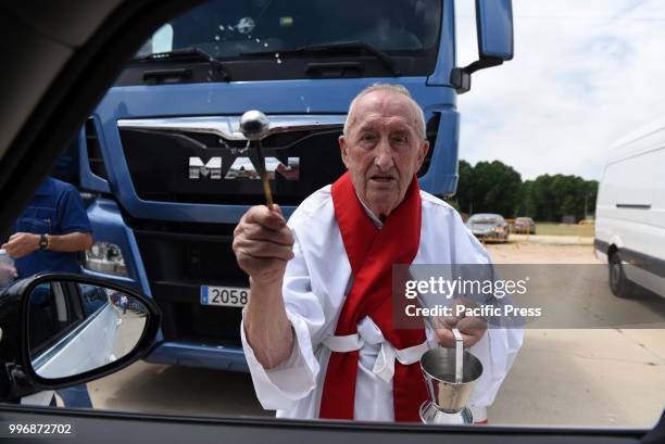 Father Jacinto Egido blesses a car on Saint Christopher's day, the patron saint of vehicles and drivers.