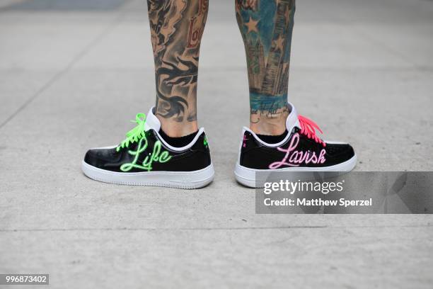 Chris Lavish is seen on the street during Men's New York Fashion Week wearing custom vest and shoes on July 11, 2018 in New York City.