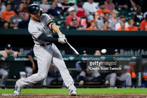 Giancarlo Stanton of the New York Yankees singles against the Baltimore Orioles during the fifth inning at Oriole Park at Camden Yards on July 11,...