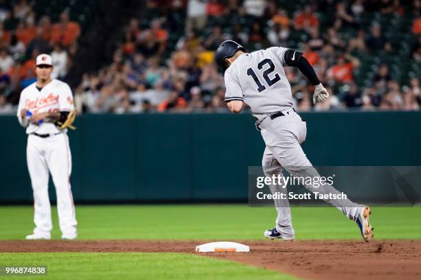 Manny Machado of the Baltimore Orioles looks on as Tyler Wade of the New York Yankees rounds second after hitting a solo home run during the sixth...