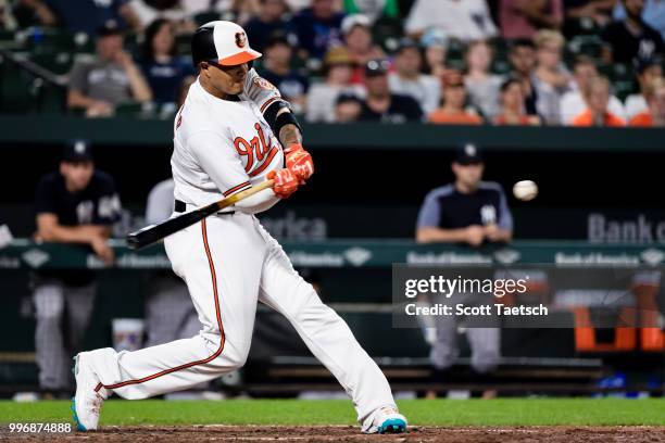 Manny Machado of the Baltimore Orioles doubles against the New York Yankees during the sixth inning at Oriole Park at Camden Yards on July 11, 2018...