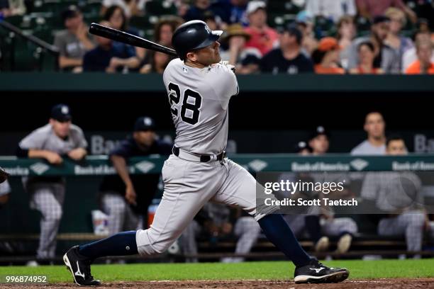 Austin Romine of the New York Yankees hits a solo home run against the Baltimore Orioles during the seventh inning at Oriole Park at Camden Yards on...