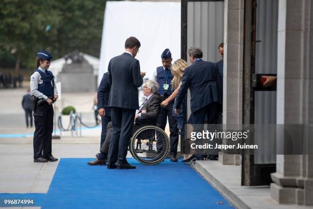 The President of the European Commission, Jean-Claude Juncker is seen seated in a wheelchair as he is brought in through a side entrance of the...