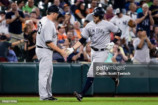 Austin Romine of the New York Yankees hits a solo home run against the Baltimore Orioles during the seventh inning at Oriole Park at Camden Yards on...