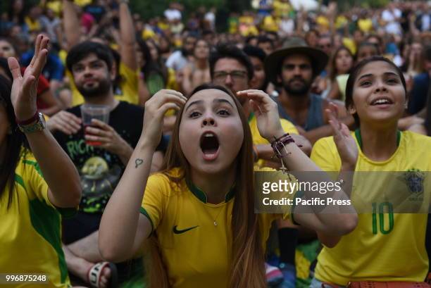 Brazil fans react as they watch the 2018 FIFA World Cup Russia Quarter Final match between Brazil and Belgium at 'Casa do Brasil' in Madrid.
