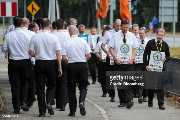 Pilots for Ryanair Holdings Plc and members of Irish Air Line Pilots' Association in Ireland's Forsa union carry signs as they march during a strike...